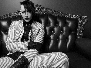 Sofa, a man, Marilyn Manson. Makeup