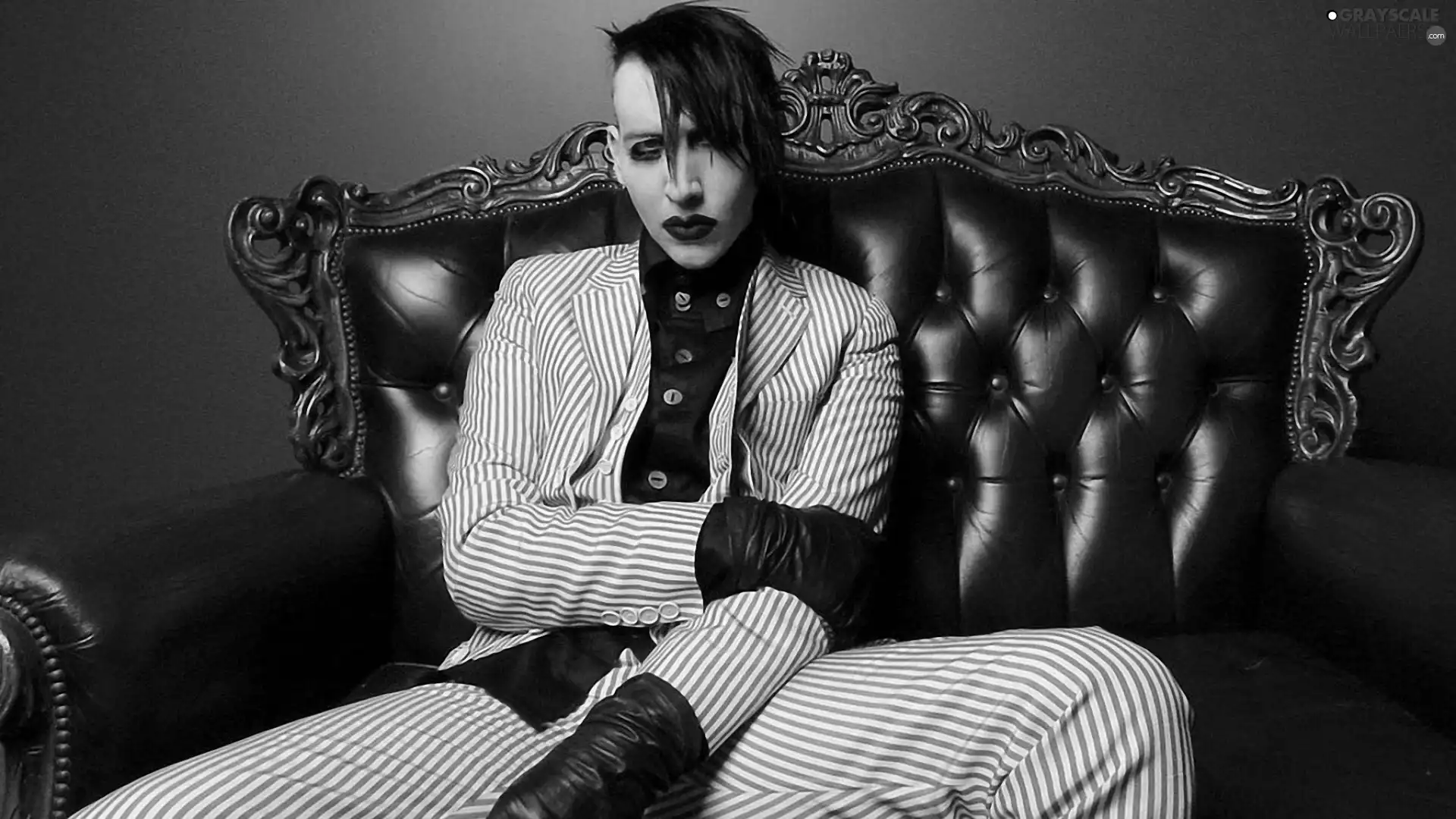 Sofa, a man, Marilyn Manson. Makeup